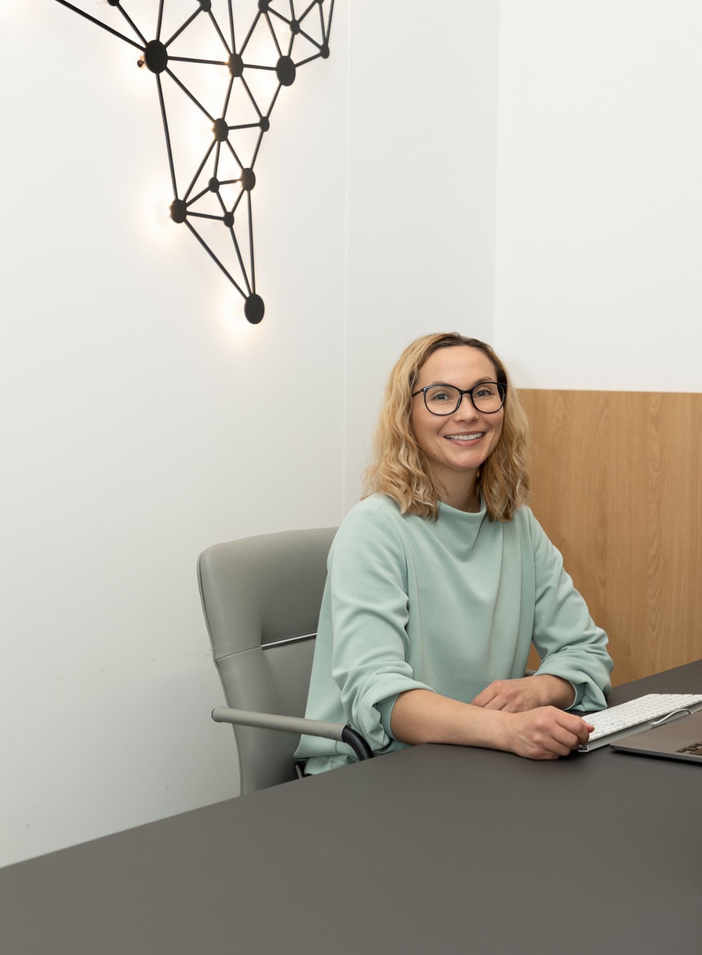 Dr. Justina Šidlauskaitė at her desk at Neuropulsas Clinic in Vilnius